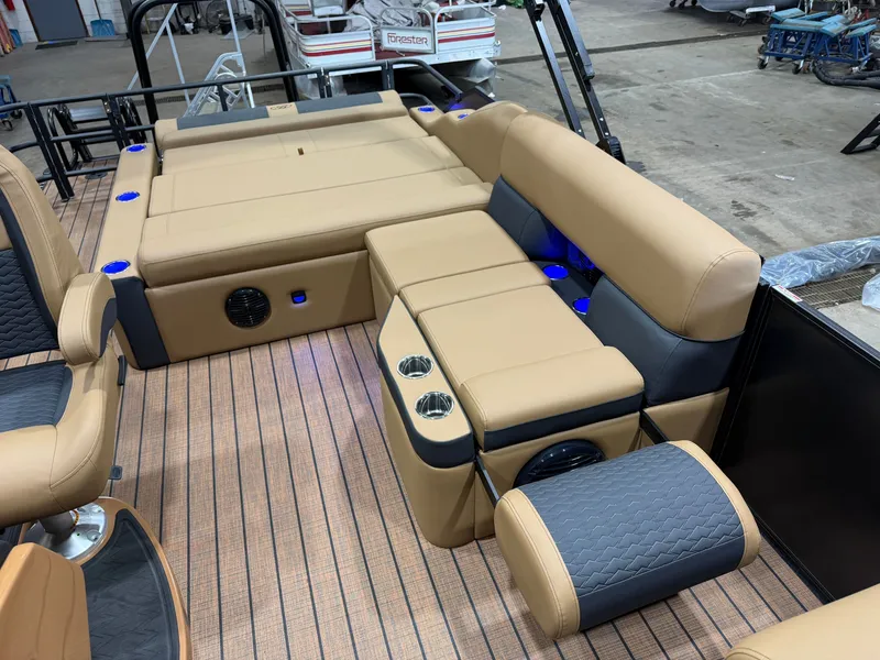 Slide: The Image of The image shows the interior of a Bentley Pontoons Elite 223 Swingback Tritoon with beige upholstery. - 24
