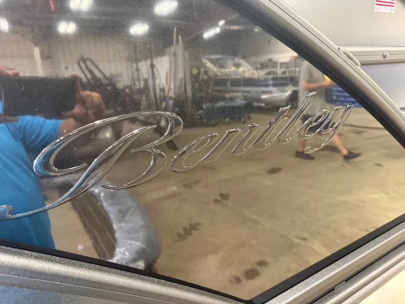 Slide: The Image of Close-up of the Bentley logo on a boat in a warehouse setting. - 44