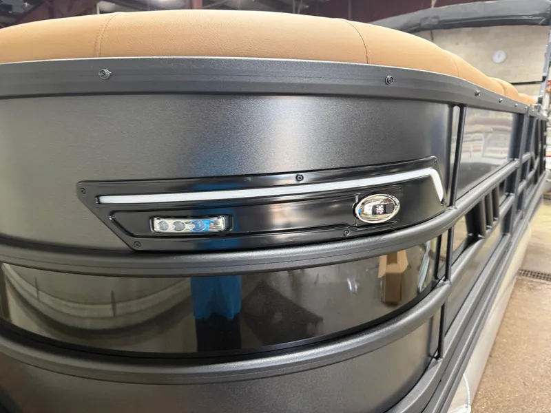 Slide: The Image of Close-up of a Bentley Pontoons Elite 223 Swingback Tritoon with sleek black details and modern design. - 42
