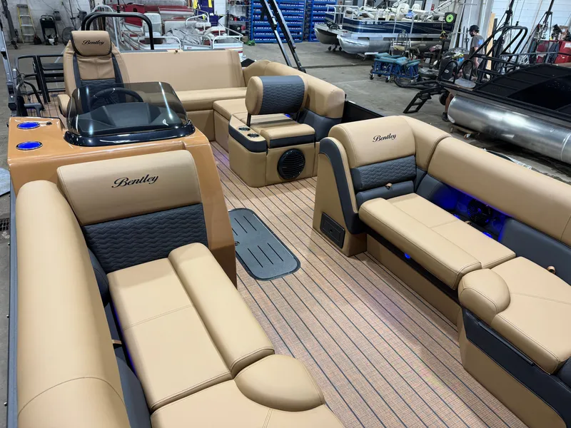Slide: The Image of Luxurious interior of a Bentley Pontoons Elite 223 Swingback Tritoon with beige upholstery and blue accents. - 40