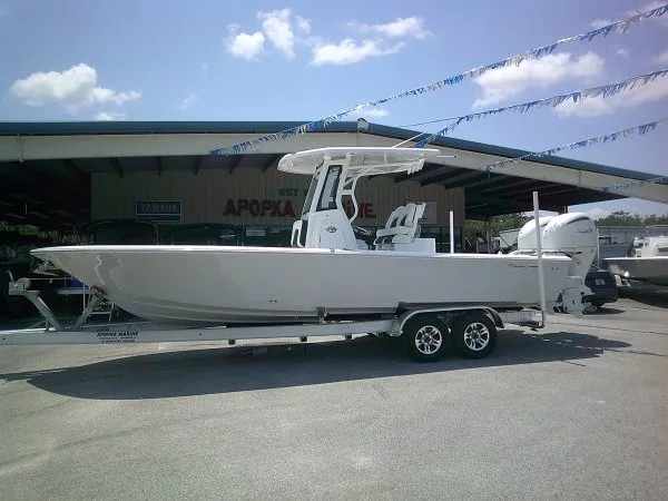The Image of A 2027 Tidewater 2700 Carolina Bay boat on a trailer in an outdoor storage area. - 1