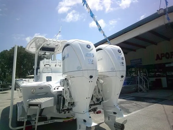 Slide: The Image of The image shows a Tidewater 2700 Carolina Bay boat with twin outboard engines on a trailer. - 21