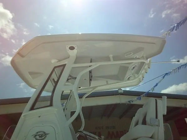 Slide: The Image of The image shows the T-top of a Tidewater 2700 Carolina Bay boat under a sunny sky. - 23