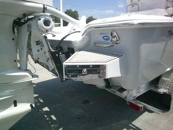 Slide: The Image of The image shows the stern of a 2027 Tidewater 2700 Carolina Bay boat with motor and platform. - 20