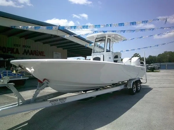 Slide: The Image of A white 2027 Tidewater 2700 Carolina Bay boat on a trailer in front of a building. - 24