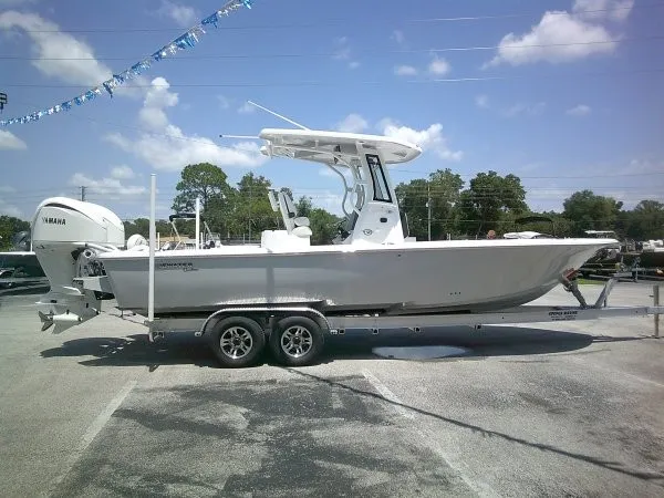 Slide: The Image of A white Tidewater 2700 Carolina Bay boat from 2027 is on a trailer outdoors. - 18
