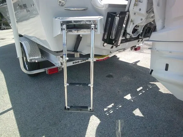 Slide: The Image of A retractable swim ladder is mounted on the stern of a boat, which is on a trailer. - 22