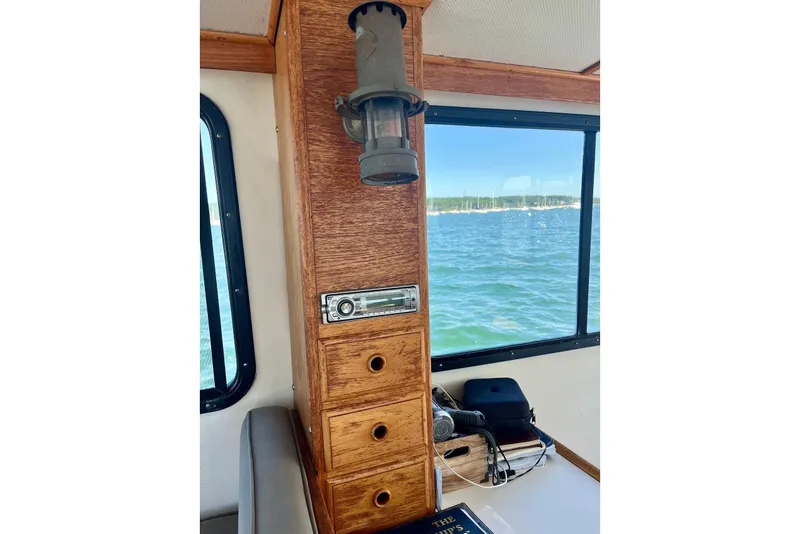 Slide: The Image of Interior of 1993 Atlantic Boat Flye Point 32, featuring wooden cabinetry and nautical decor. - 18
