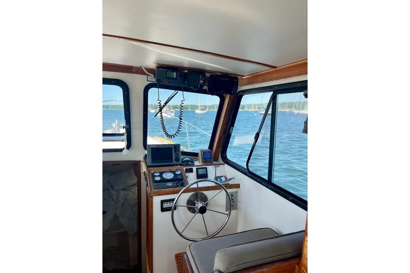 Slide: The Image of Interior view of 1993 Atlantic Boat Flye Point 32 helm with ocean backdrop. - 23