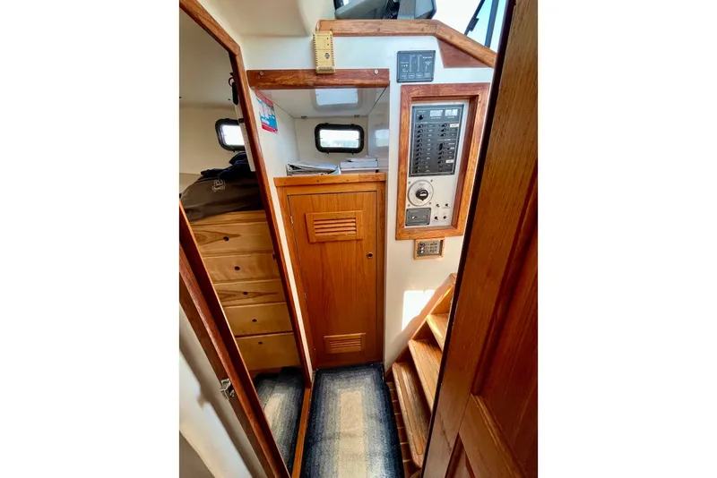 Slide: The Image of Interior of 1993 Atlantic Boat Flye Point 32, featuring wooden cabinetry and control panel. - 15