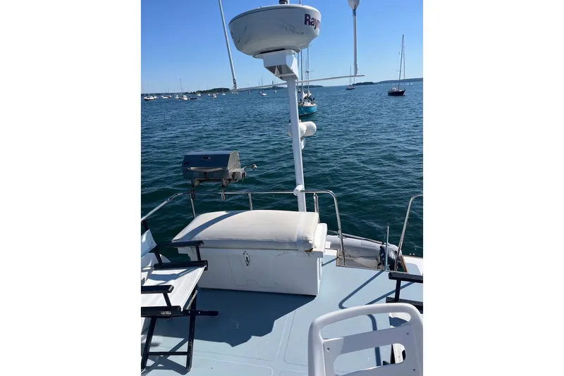 Slide: The Image of Atlantic Boat Flye Point 32, 1993 model, on calm waters with seating and radar. - 19