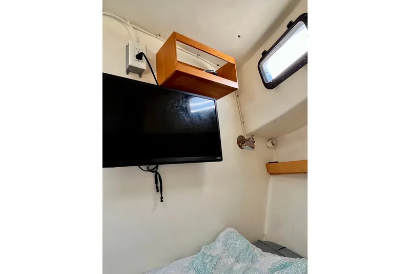 Slide: The Image of Interior of 1993 Atlantic Boat Flye Point 32 with TV, shelf, and window. - 14