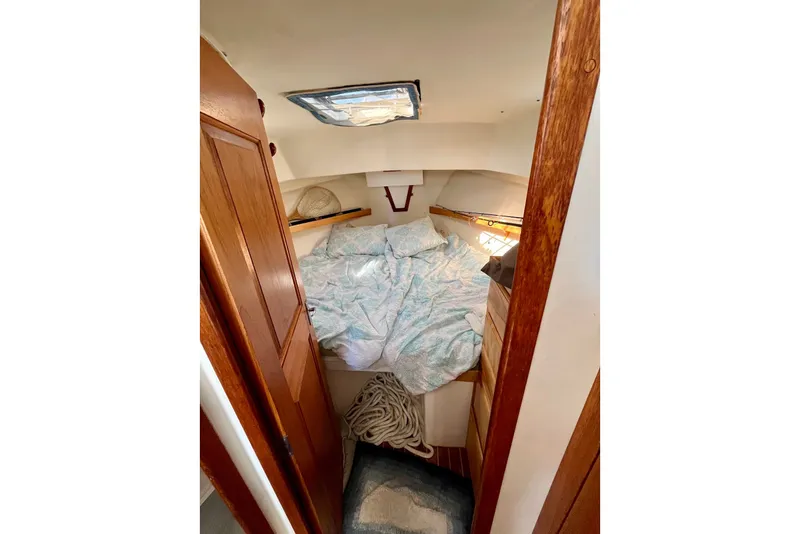Slide: The Image of Cozy cabin interior of 1993 Atlantic Boat Flye Point 32 with wooden accents and bedding. - 16