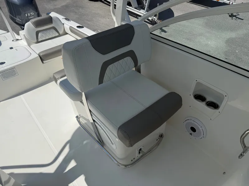 Slide: The Image of A modern boat seat with gray and white upholstery, surrounded by a clean deck area. - 2