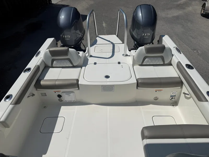 Slide: The Image of The image shows the stern of a World Cat 230 DC boat with two outboard engines. - 4