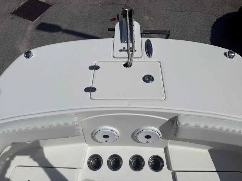 Slide: The Image of The image shows the deck of a 2023 World Cat 230 DC boat with anchor and storage compartments. - 14