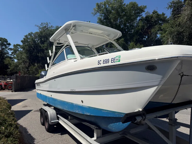 Slide: The Image of A 2023 World Cat 230 DC on a trailer, featuring a blue hull and white superstructure. - 13