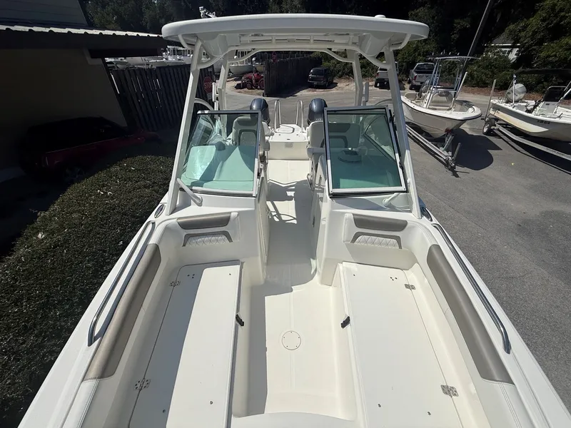 Slide: The Image of The image shows a 2023 World Cat 230 DC boat with a spacious deck and dual consoles. - 16