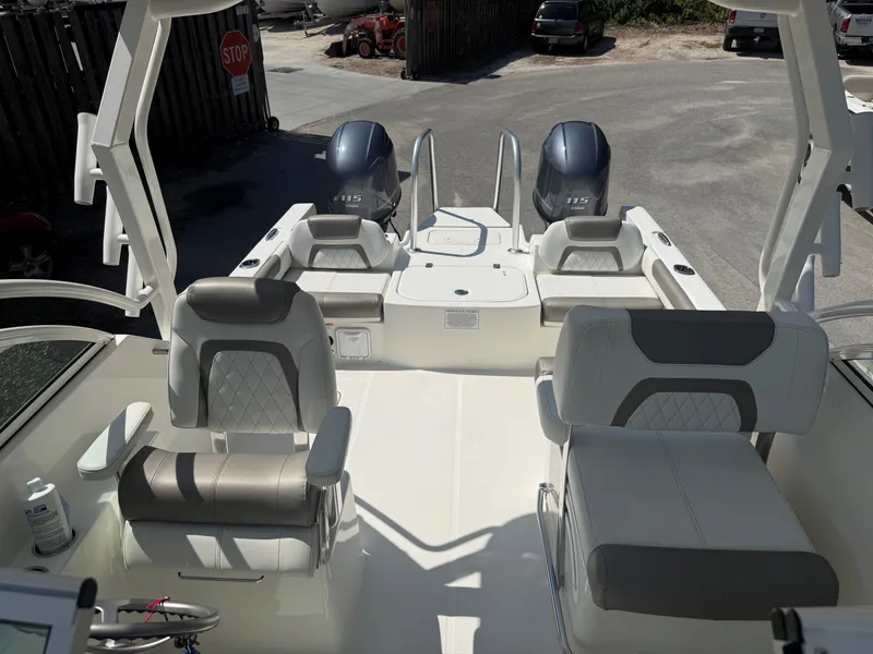 Slide: The Image of The image shows the cockpit of a 2023 World Cat 230 DC with two outboard engines. - 15