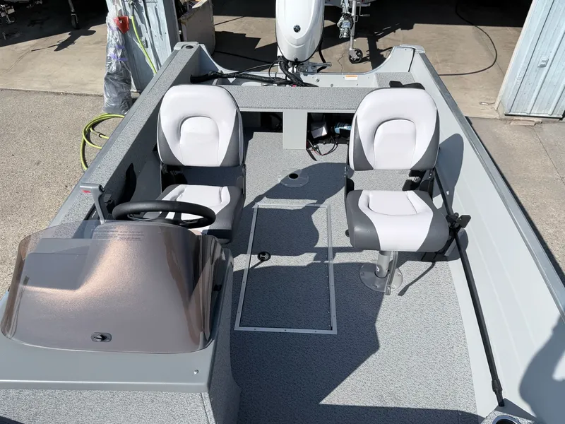 Slide: The Image of The image shows a 2027 Starcraft 16 Patriot DLX SC boat with two seats and a helm. - 29