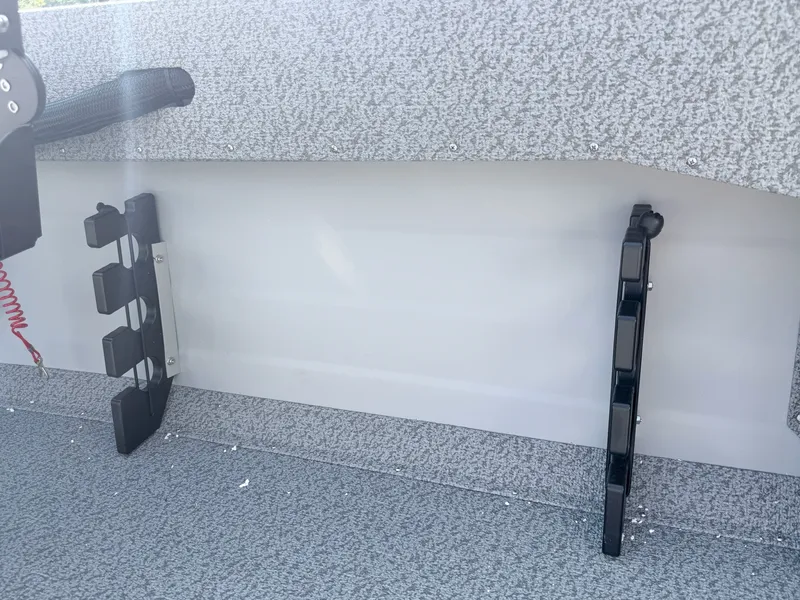 Slide: The Image of The image shows the interior of a Starcraft 16 Patriot DLX SC boat with gray carpeting. - 18