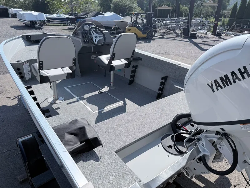 Slide: The Image of The image shows a 2027 Starcraft 16 Patriot DLX SC boat with a Yamaha outboard motor. - 26