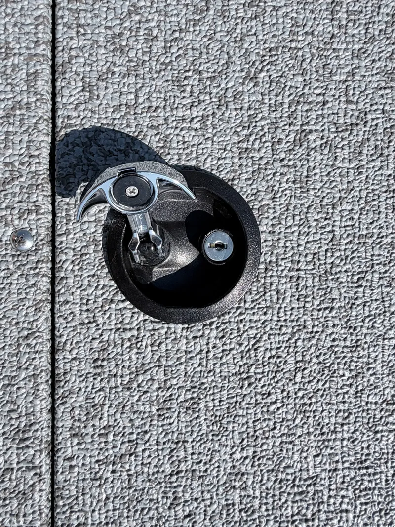 Slide: The Image of Close-up of a boat latch on a textured surface. - 25