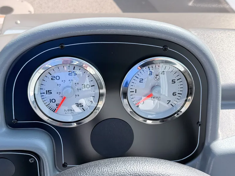 Slide: The Image of Close-up of two analog gauges on a boat panel, showing speed and RPM. - 22