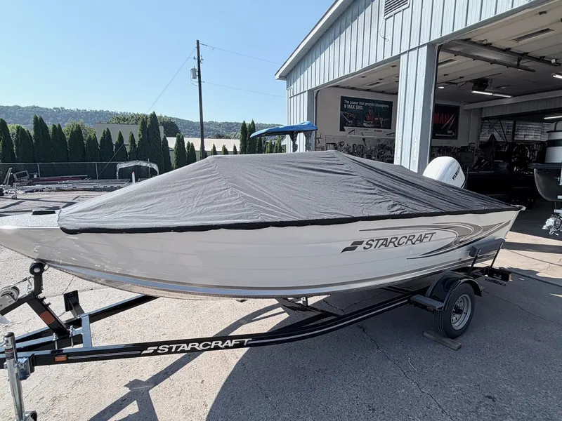Slide: The Image of A 2027 Starcraft 16 Patriot DLX SC boat on a trailer, covered with a tarp. - 14