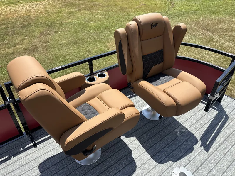 Slide: The Image of Two luxurious, cushioned seats on a boat with wood-look flooring and cup holders. - 14