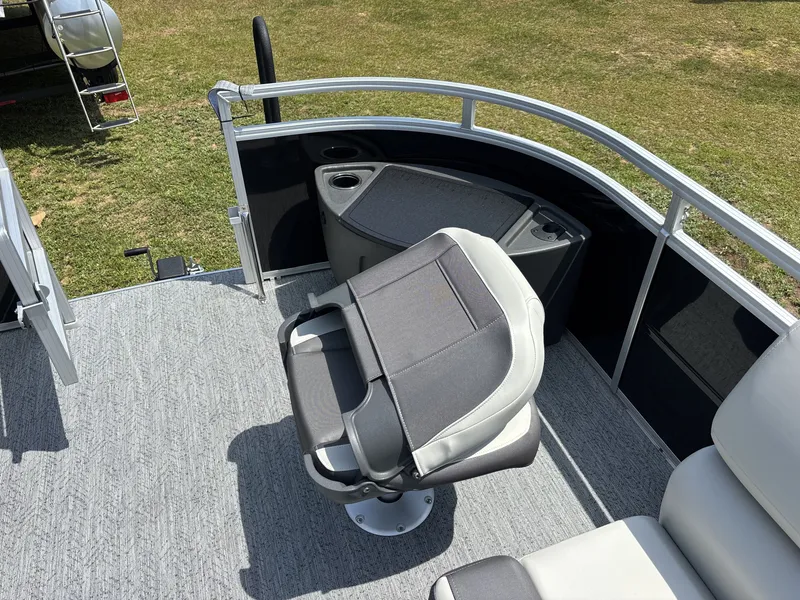 Slide: The Image of A modern boat seat on a 2026 Sun Tracker Fishin' Barge 20 DLX, featuring gray carpet flooring. - 15
