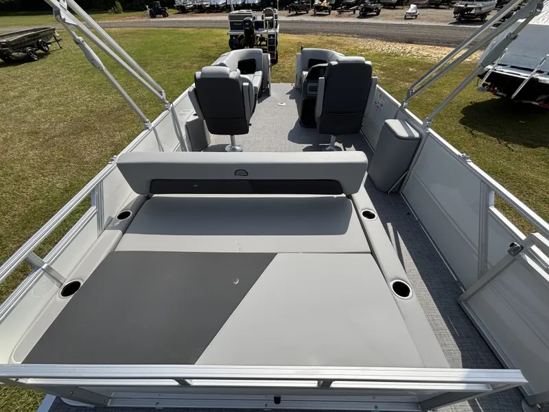 Slide: The Image of The image shows a 2026 Sun Tracker Party Barge 22 RF DLX pontoon boat with gray seating and a spacious deck. - 17