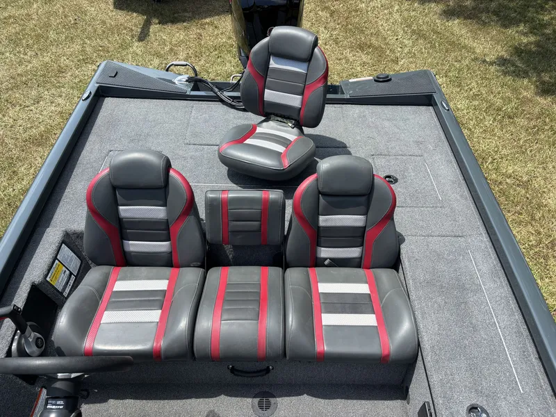 Slide: The Image of The image shows the cockpit of a 2025 Ranger RT RT188C boat with gray and red seats. - 15