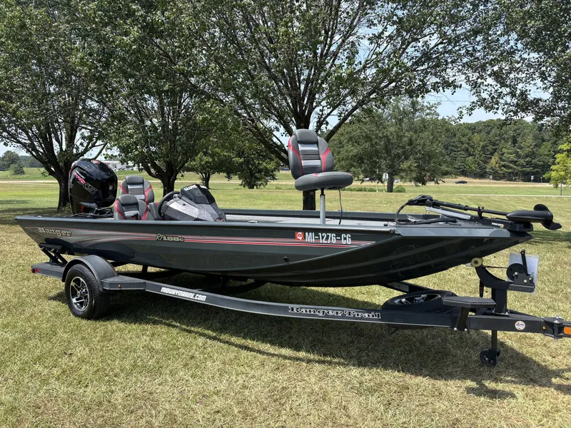 Slide: The Image of A gray 2025 Ranger RT RT188C boat on a trailer, set on a grassy field. - 4
