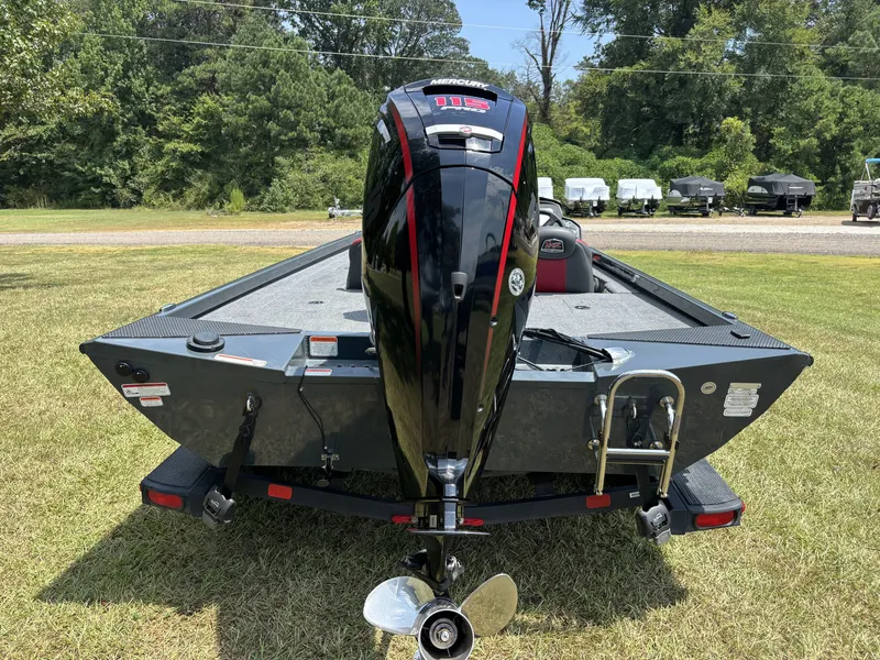 Slide: The Image of A 2025 Ranger RT RT188C boat with an outboard motor, parked on a grassy area. - 7