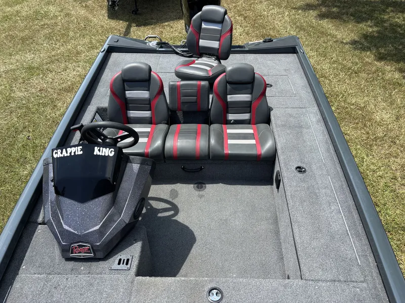 Slide: The Image of The image shows a 2025 Ranger RT RT188C boat with gray and red seating. - 13