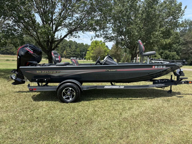 The Image of A 2025 Ranger RT RT188C boat on a trailer, parked on grass, with trees in the background. - 1