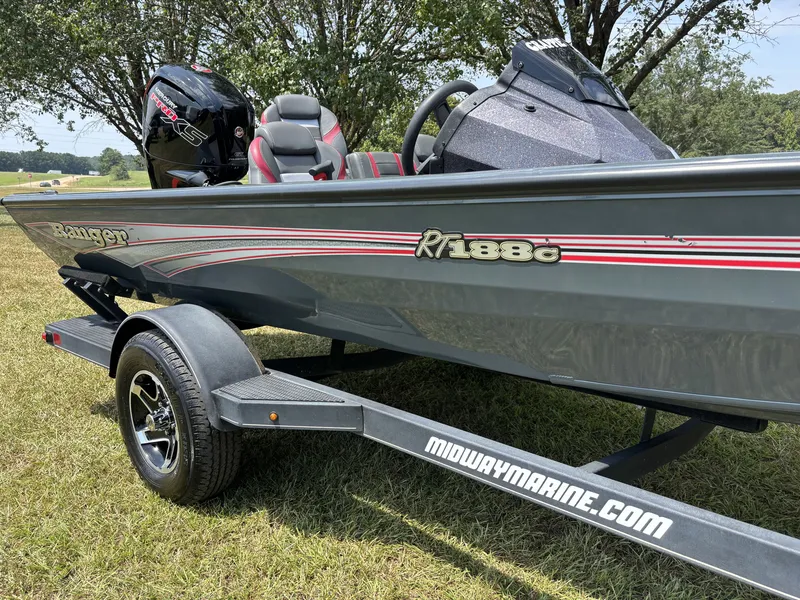 Slide: The Image of A gray 2025 Ranger RT188C boat on a trailer, parked on grass. - 5