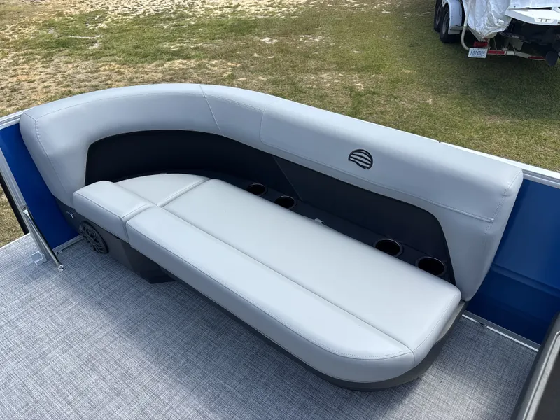 Slide: The Image of The image shows a gray seating area on a boat with blue side panels and carpeted flooring. - 15