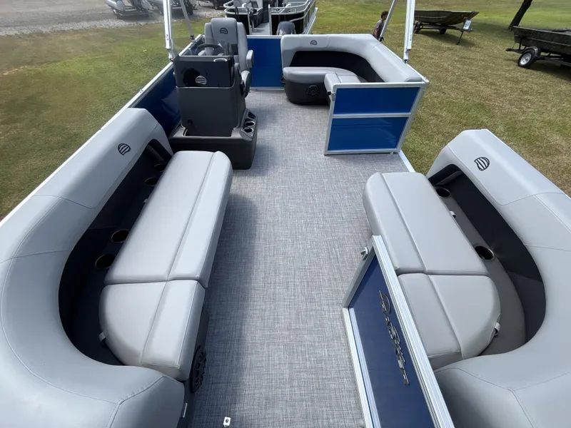 Slide: The Image of The image shows the spacious deck of a 2027 Sun Tracker Party Barge 16 DLX with gray seating. - 14