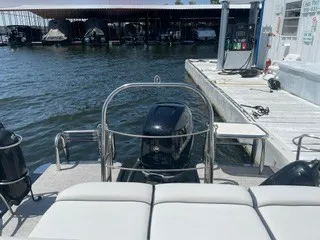 Slide: The Image of The image shows the stern of a 2022 Harris Grand Mariner 250 with an outboard motor. - 24