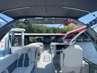 Slide: The Image of The image shows the interior of a 2022 Harris Grand Mariner 250 with gray seating and a canopy. - 25