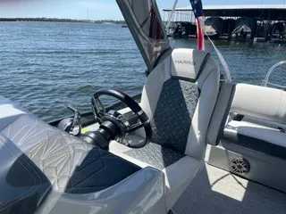 Slide: The Image of The image shows the cockpit of a 2022 Harris Grand Mariner 250 with a sleek steering wheel. - 19