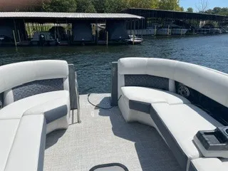 Slide: The Image of The image shows the deck of a 2022 Harris Grand Mariner 250 with white seating. - 22
