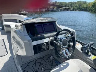 Slide: The Image of The image shows the helm of a 2022 Harris Grand Mariner 250 on a lake. - 20