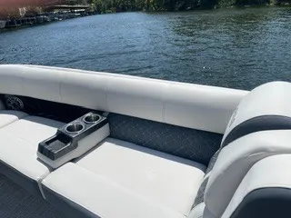 Slide: The Image of The image shows the white seating of a 2022 Harris Grand Mariner 250 on calm water. - 16