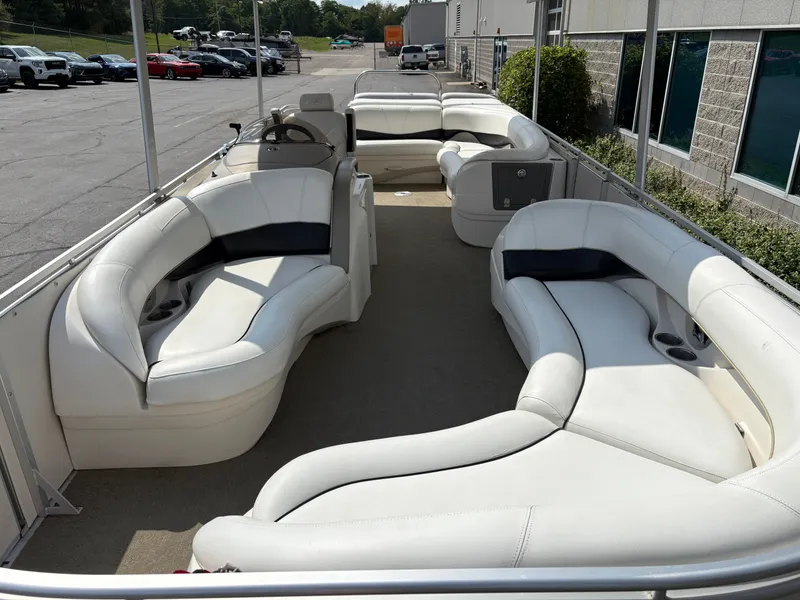 Slide: The Image of The image shows the interior of a 2006 Harris Royal Herritage pontoon boat with white leather seating. - 18