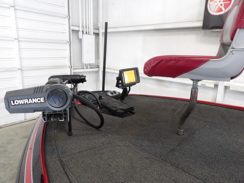 Slide: The Image of A 2010 Nitro Z-7 boat with a Lowrance fish finder and elevated seat on gray carpet. - 3