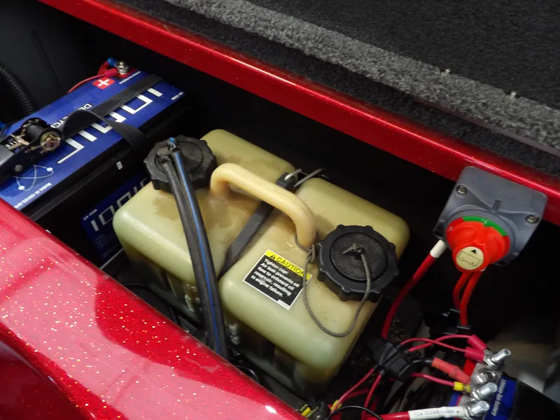 Slide: The Image of A view inside the battery compartment of a 2010 Nitro Z-7 boat with battery and fuel tank. - 25