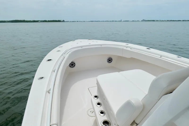 Slide: The Image of 2025 Fountain 34 Tournament Edition boat on calm water, showcasing sleek design and seating. - 31